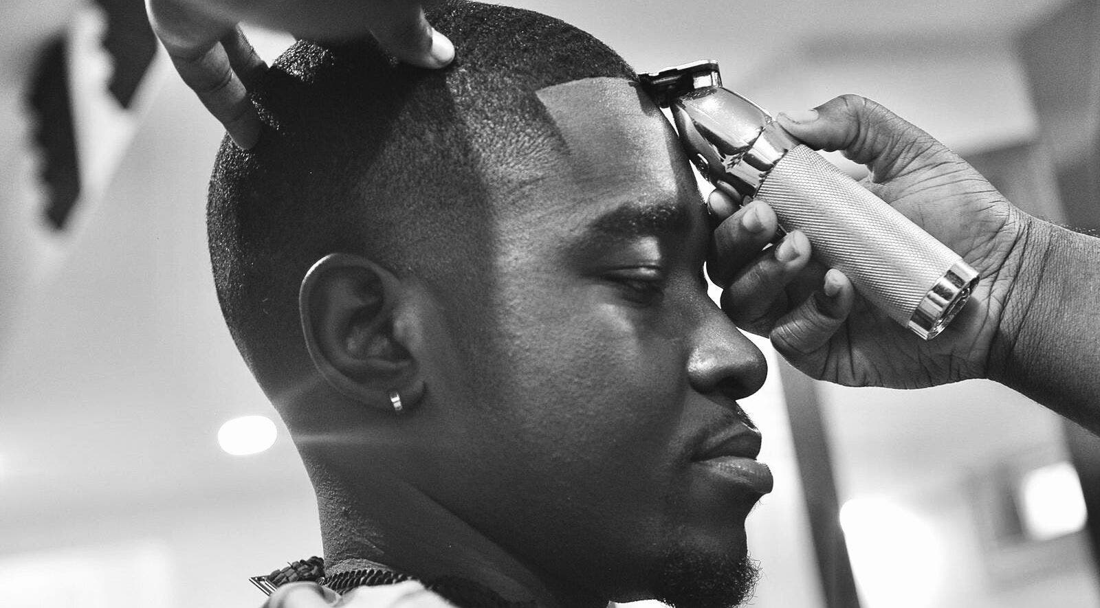 Close-up of a barber giving a haircut at Sid the Barber in Oshawa, Ontario, CA, showcasing expert grooming.