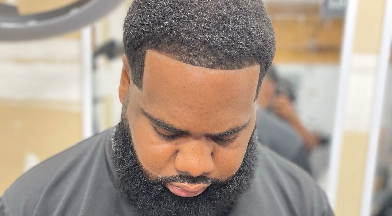 Close-up of a client's fresh haircut at Sid the Barber in Oshawa, Ontario, CA, showcasing sharp lines and beard styling.