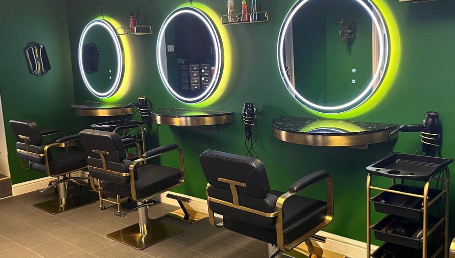 Stylish interior of Halo Hair Salon in Malton, England, GB with illuminated mirrors and black chairs.