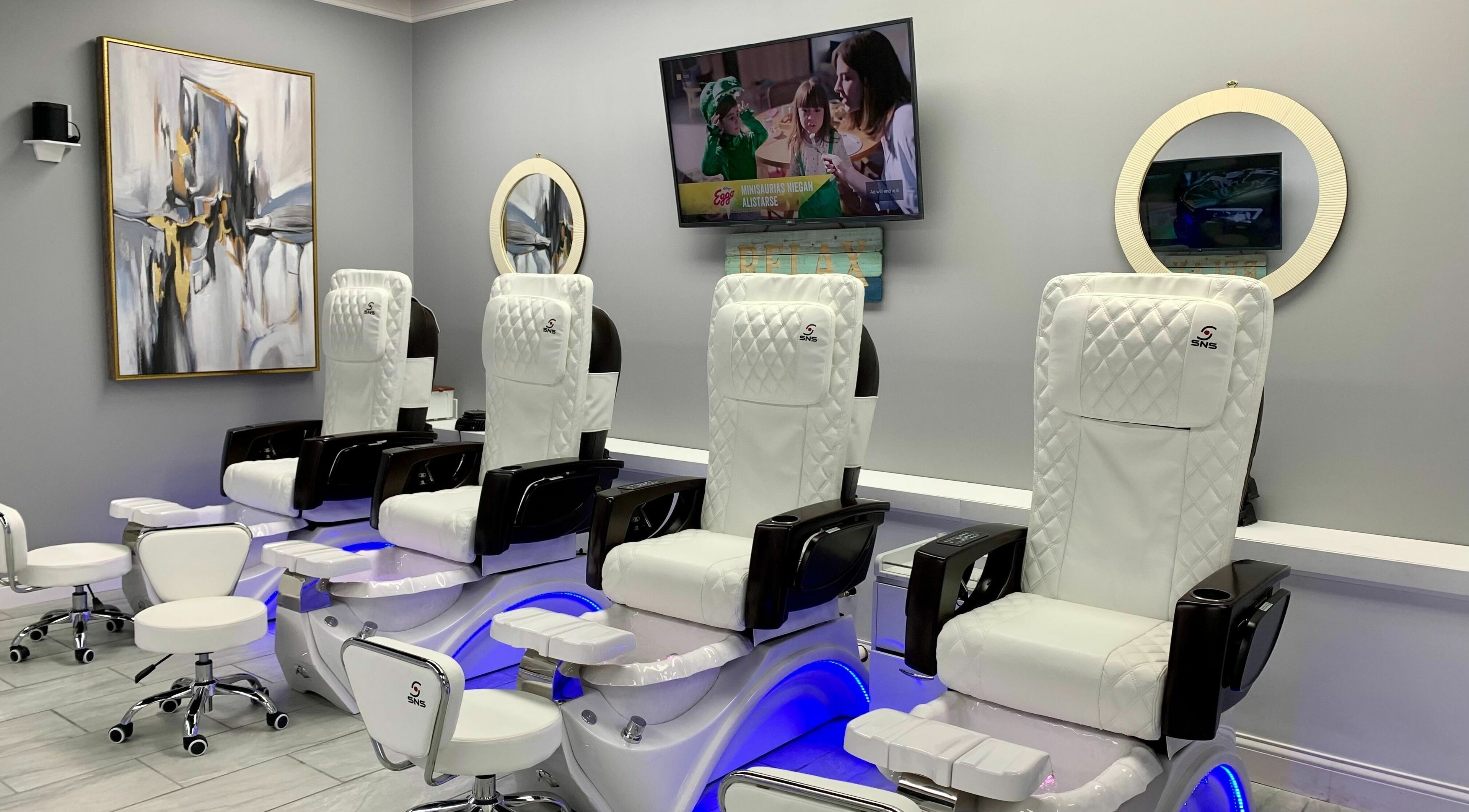 Elegant pedicure chairs at Artist Nails in Hartland, Michigan, US, showcasing modern salon luxury.