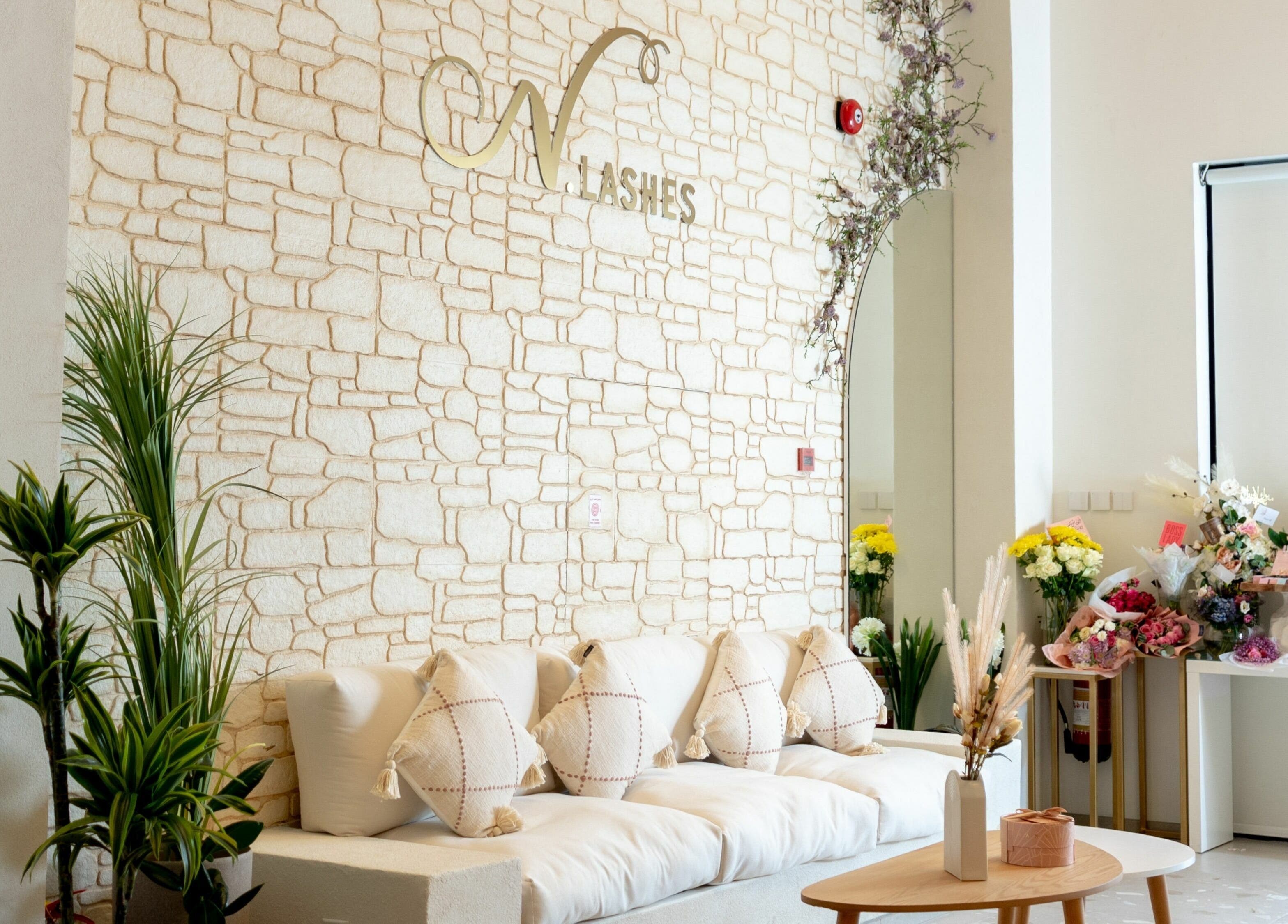 Elegant lounge at N.Lashes Al Khobar, Eastern Province, SA featuring comfy seating and floral decor.