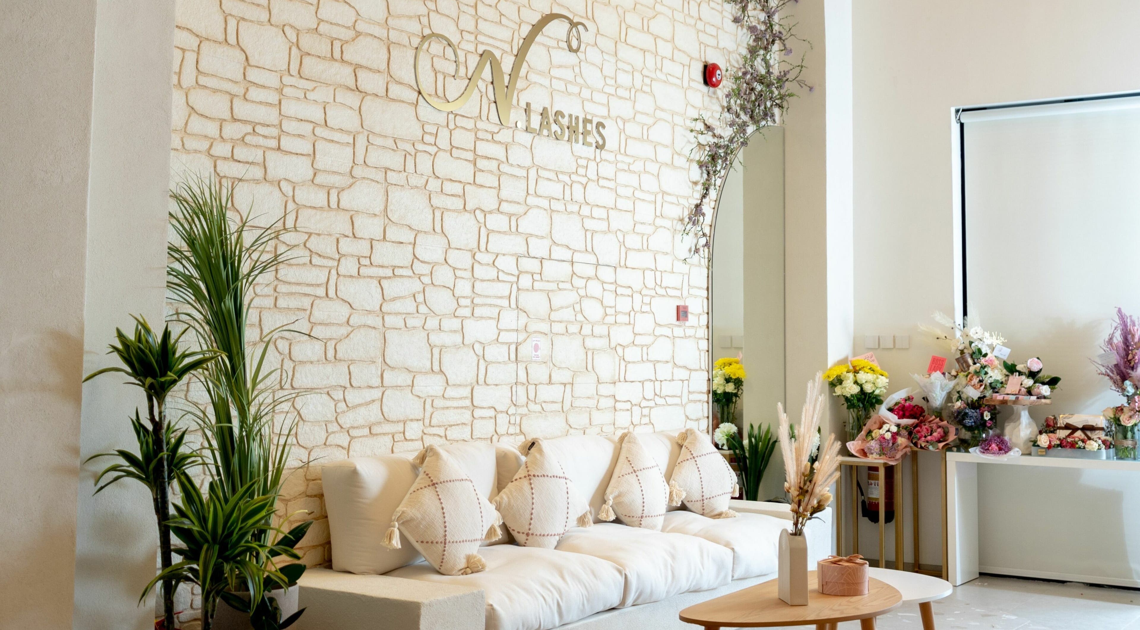 Elegant lounge at N.Lashes Al Khobar, Eastern Province, SA featuring comfy seating and floral decor.