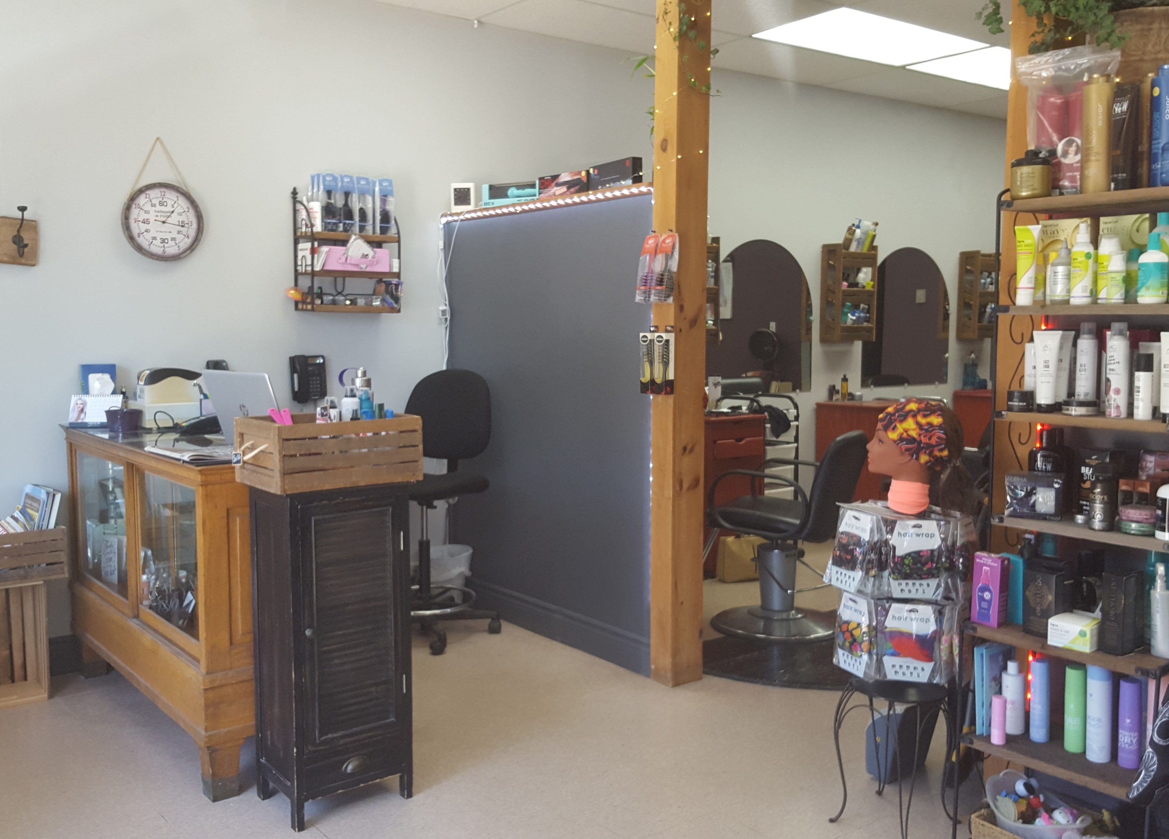 Cozy interior of Orillia Hair in Orillia, Ontario, CA, showcasing products and styling chairs.