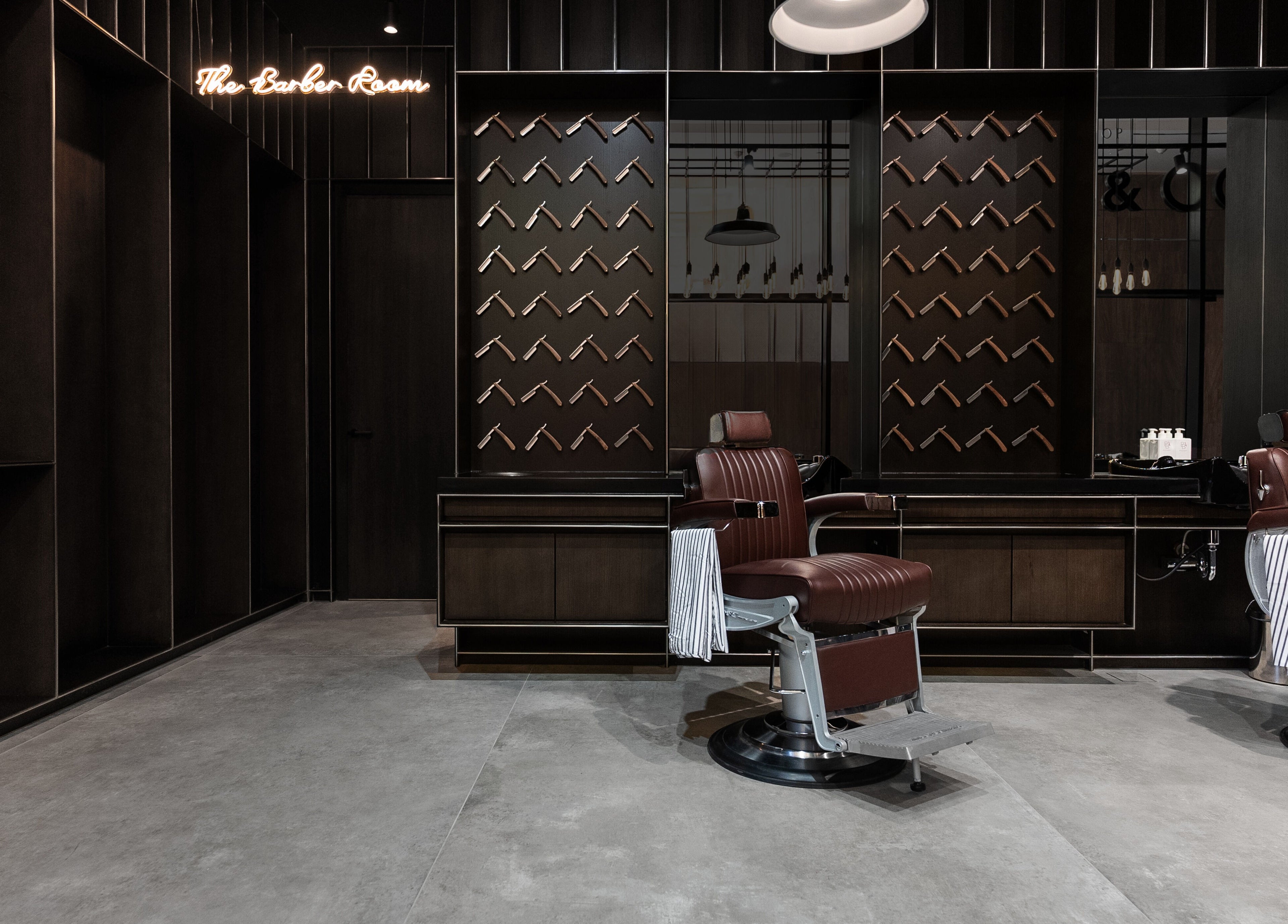 Luxurious barber chairs at Chaps & Co - VIA Riyadh, Riyadh Province, SA, showcasing modern design.
