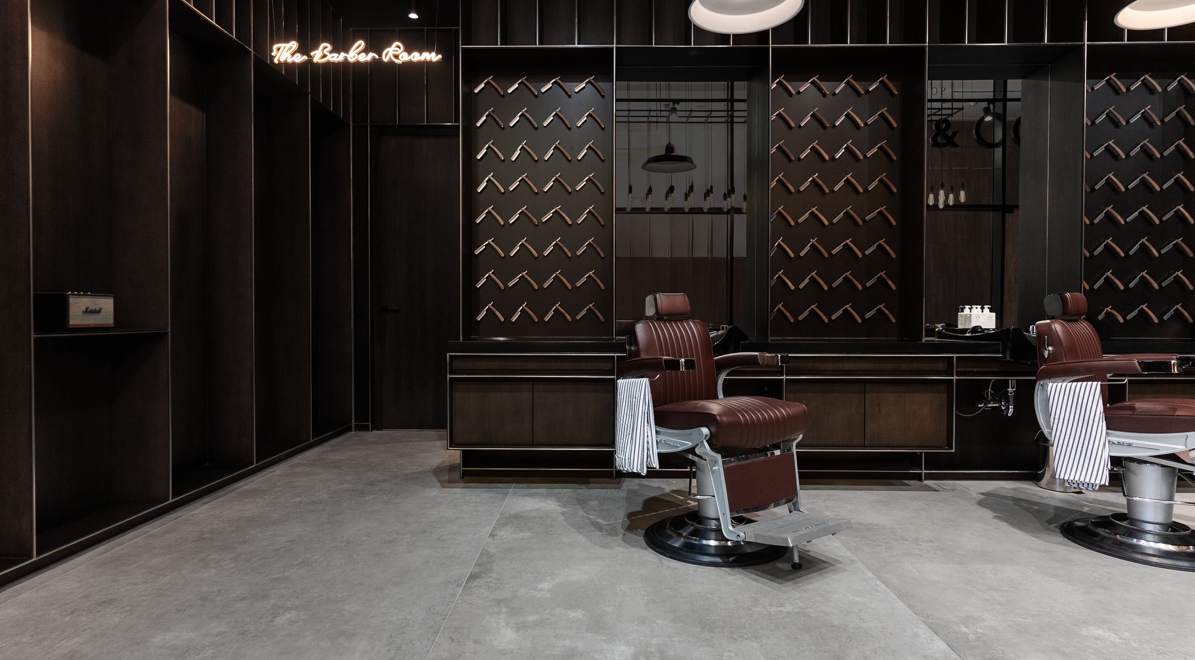 Luxurious barber chairs at Chaps & Co - VIA Riyadh, Riyadh Province, SA, showcasing modern design.