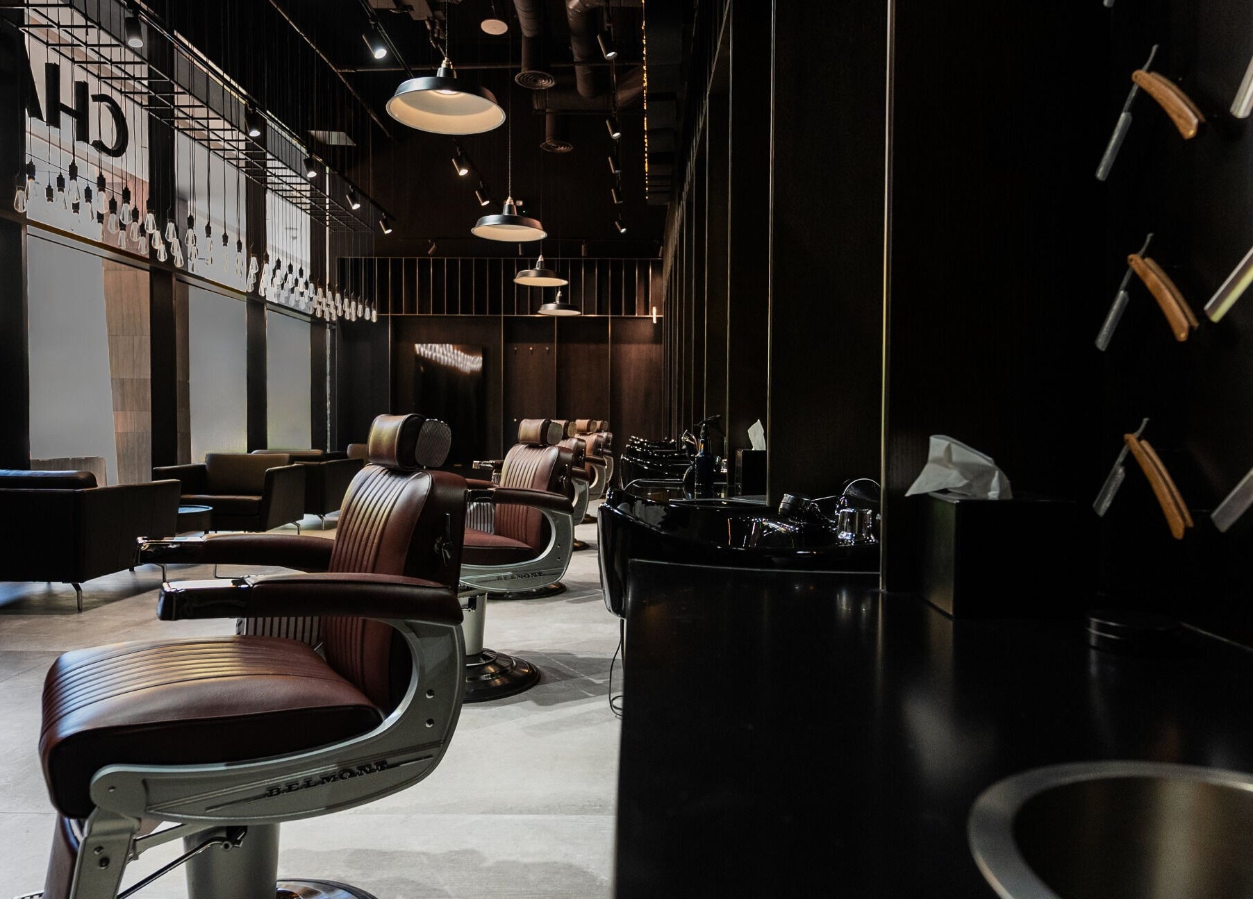Modern interior of Chaps & Co - VIA Riyadh in Riyadh, SA, featuring stylish barber chairs and decor.