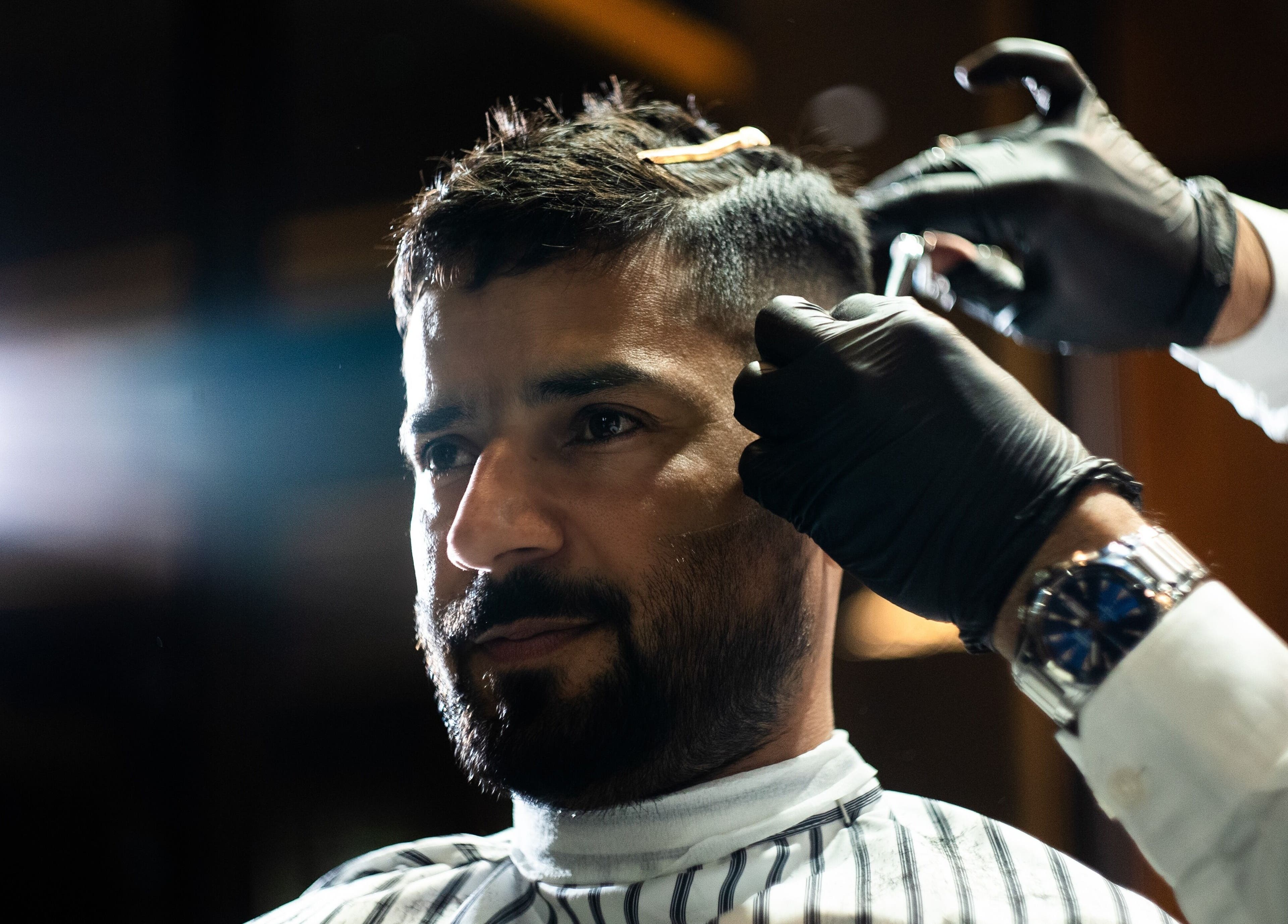 Man receiving a haircut at Chaps & Co - VIA Riyadh, Riyadh, Riyadh Province, SA, showcasing detailed grooming.