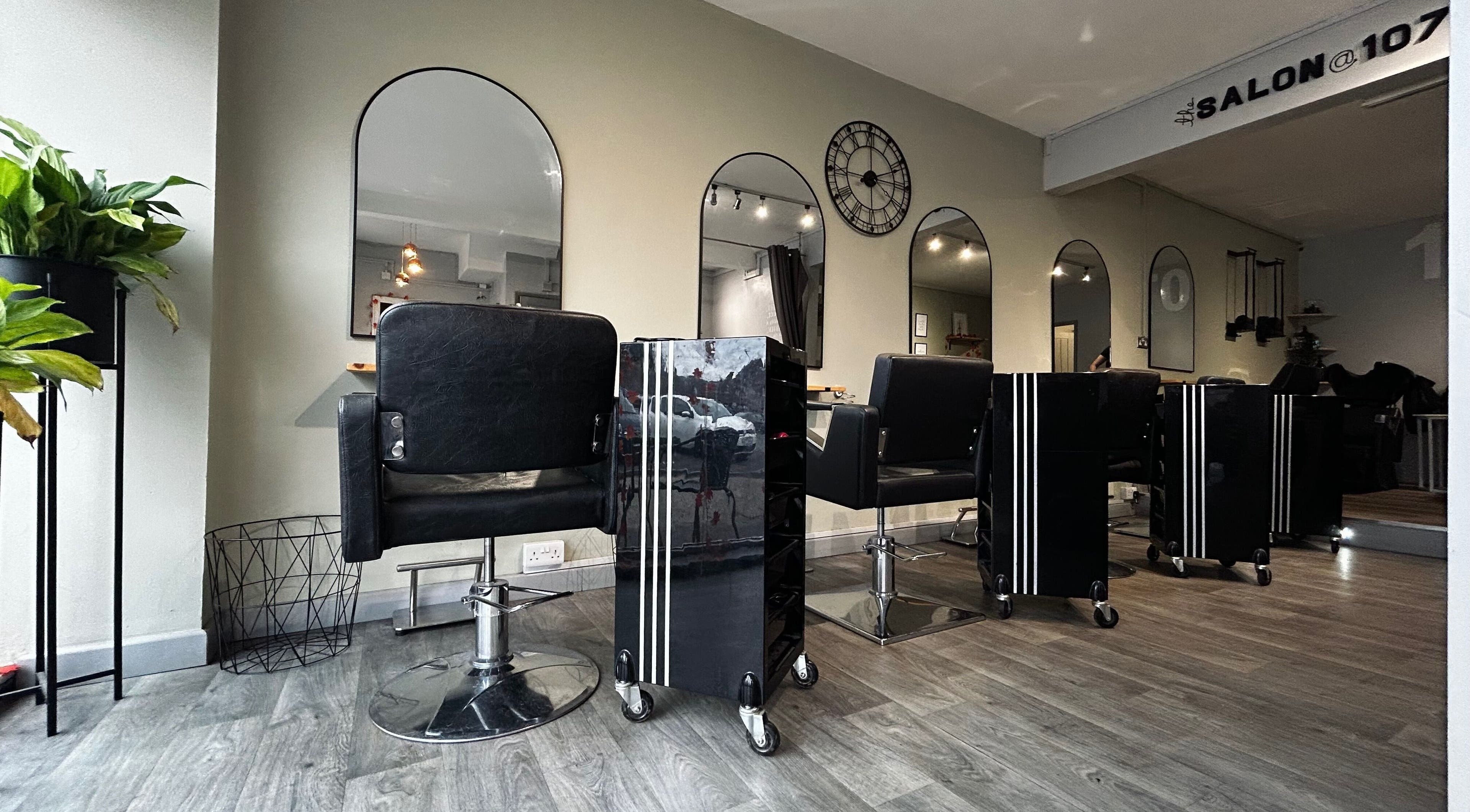 Modern interior of The Salon @ 107 in Braunstone Town, England, GB with sleek styling chairs and mirrors.
