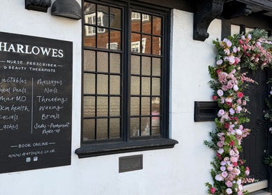 Harlowes & Sophie Rae Medical's elegant facade with floral decoration in Sandwich, England, GB.