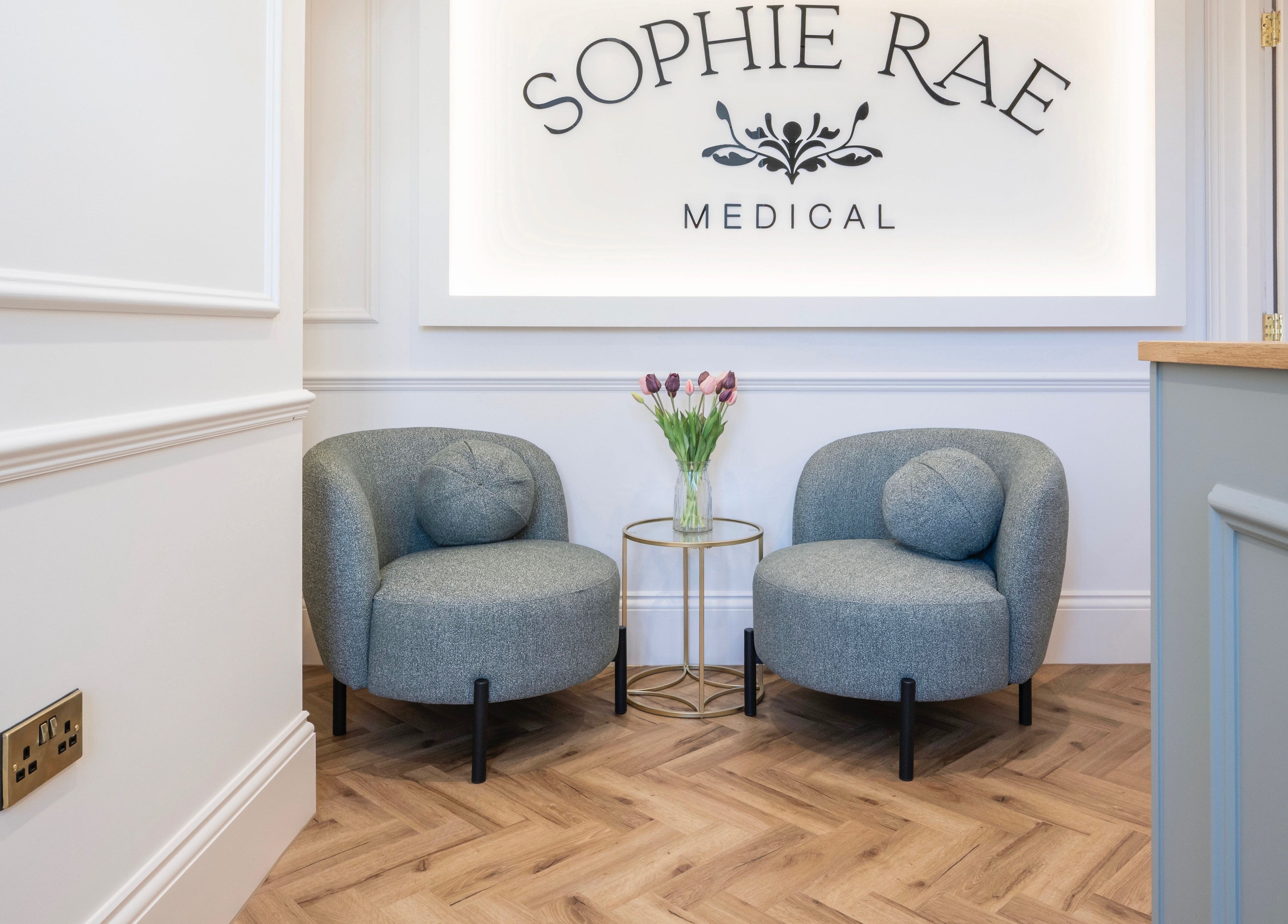 Elegant seating area at Harlowes & Sophie Rae Medical, Sandwich, England, GB with chic chairs and floral decor.