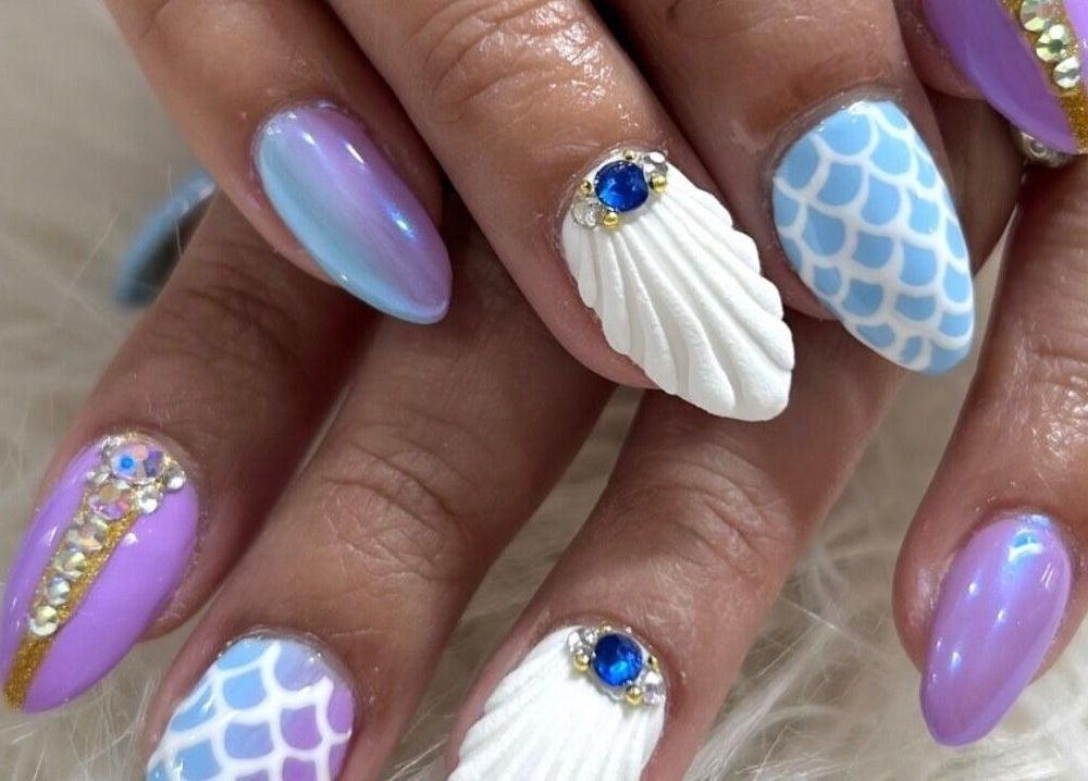 Stylish mermaid-themed nails at Glamor Nails, Bound Brook, New Jersey, US with iridescent and scale designs.