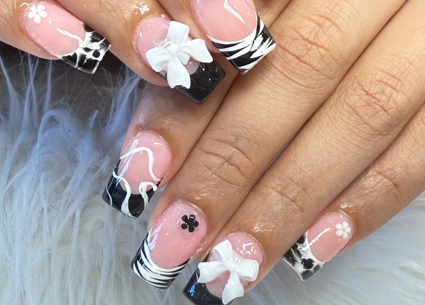 Elegant nail art at Glamor Nails in Bound Brook, New Jersey, US showcases intricate black and white patterns.