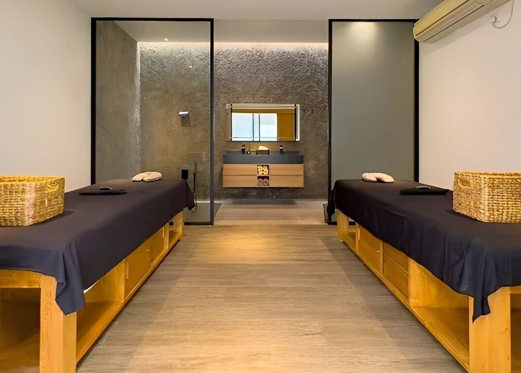 Tranquil massage room at Flow Beauty Lab, Bali, Bali, ID with dual tables and a soothing ambiance.