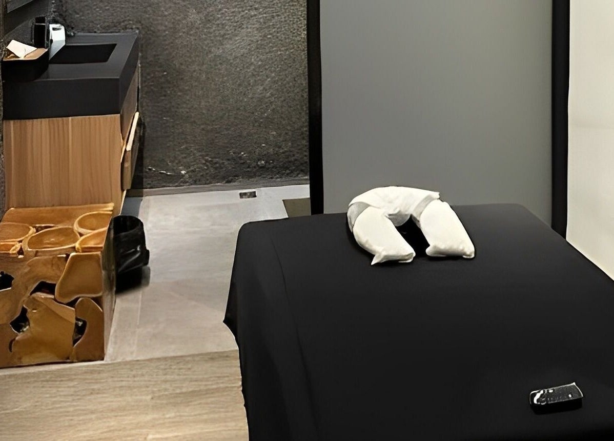 Peaceful spa room at Flow Beauty Lab, Bali, Bali, ID with massage table and modern decor for relaxation.