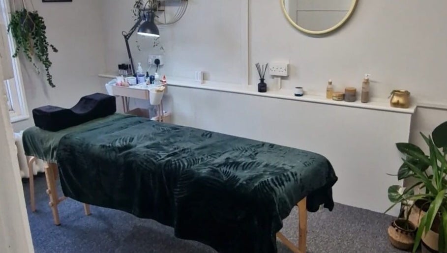 Calm treatment room at True Lashes, House Of Beauty Framlingham, England, GB with spa bed and plants.