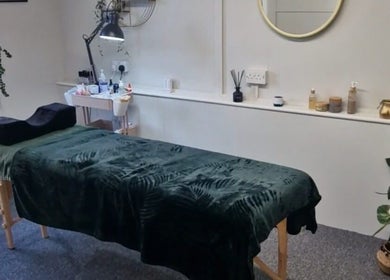 Calm treatment room at True Lashes, House Of Beauty Framlingham, England, GB with spa bed and plants.