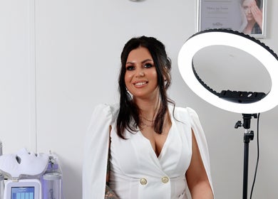 Smiling woman in Aesthetics and Beauty by Natalia's studio with beauty equipment in Edinburgh, Scotland, GB.