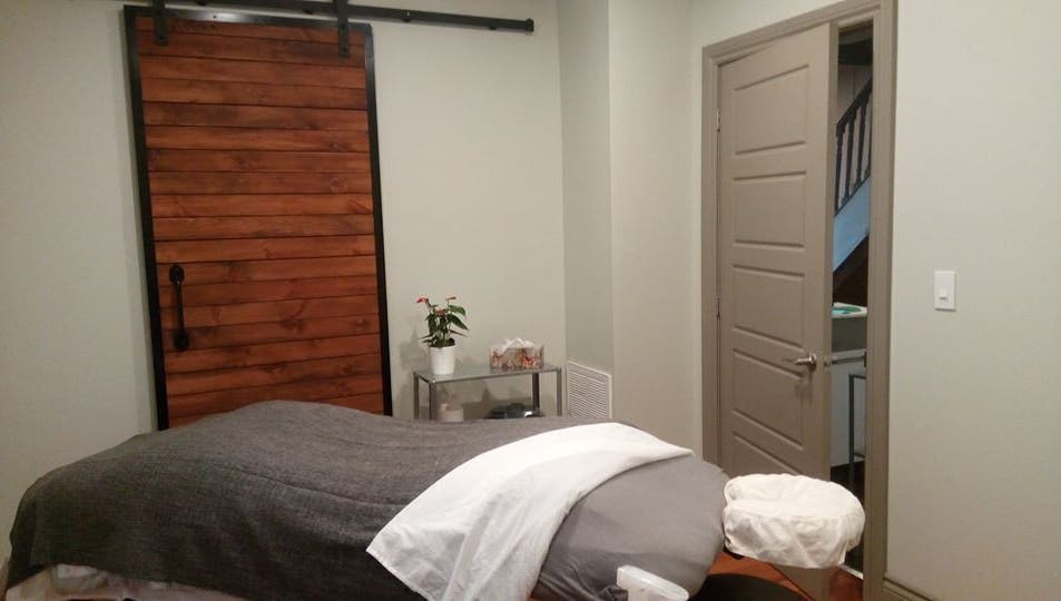 Serene massage room at Loosen Up in Cambridge, Ontario, CA with a cozy, inviting ambience.