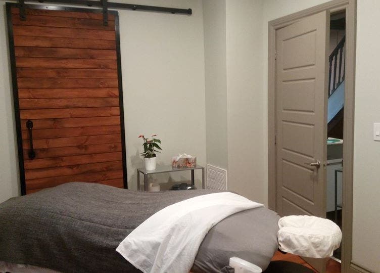 Serene massage room at Loosen Up in Cambridge, Ontario, CA with a cozy, inviting ambience.