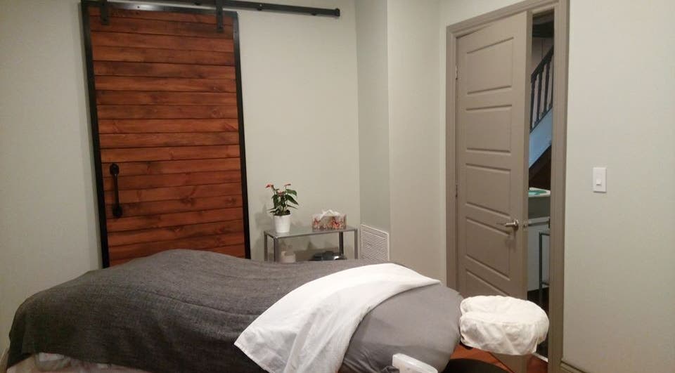 Serene massage room at Loosen Up in Cambridge, Ontario, CA with a cozy, inviting ambience.