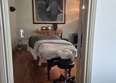 Relaxing massage room at Loosen Up, Cambridge, Ontario, CA with massage table and elephant art.