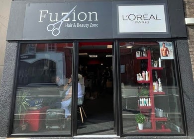 Front view of Fuzion Hair & Beauty Zone in Stonehouse, England showcasing salon entrance and products.
