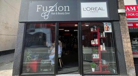 Front view of Fuzion Hair & Beauty Zone in Stonehouse, England showcasing salon entrance and products.