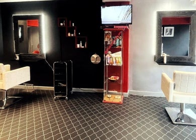 Modern salon setup at Fuzion Hair & Beauty Zone, Stonehouse, England, GB. Stylish chairs and illuminated mirrors.