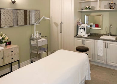 Relaxing treatment room at Fleuri Beauty and Spa, Markham, Ontario, CA with a massage table and calming decor.
