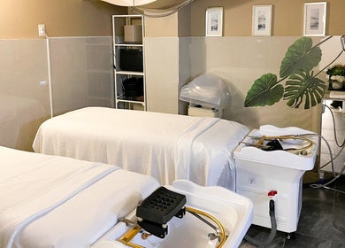 Serene spa treatment room at Fleuri Beauty and Spa, Markham, Ontario, CA with massage beds and decor.