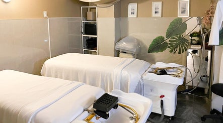 Serene spa treatment room at Fleuri Beauty and Spa, Markham, Ontario, CA with massage beds and decor.