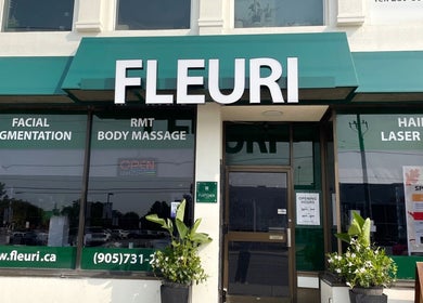 Front view of Fleuri Beauty and Spa in Markham, Ontario, CA with green signage and service listings.