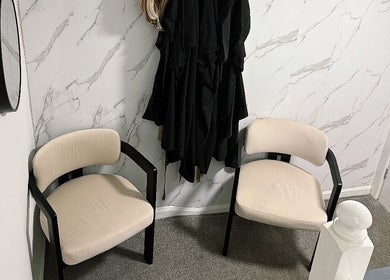 Chic seating at BLUSH Market Weighton, Market Weighton, England, GB with beige chairs and marble-pattern wall.