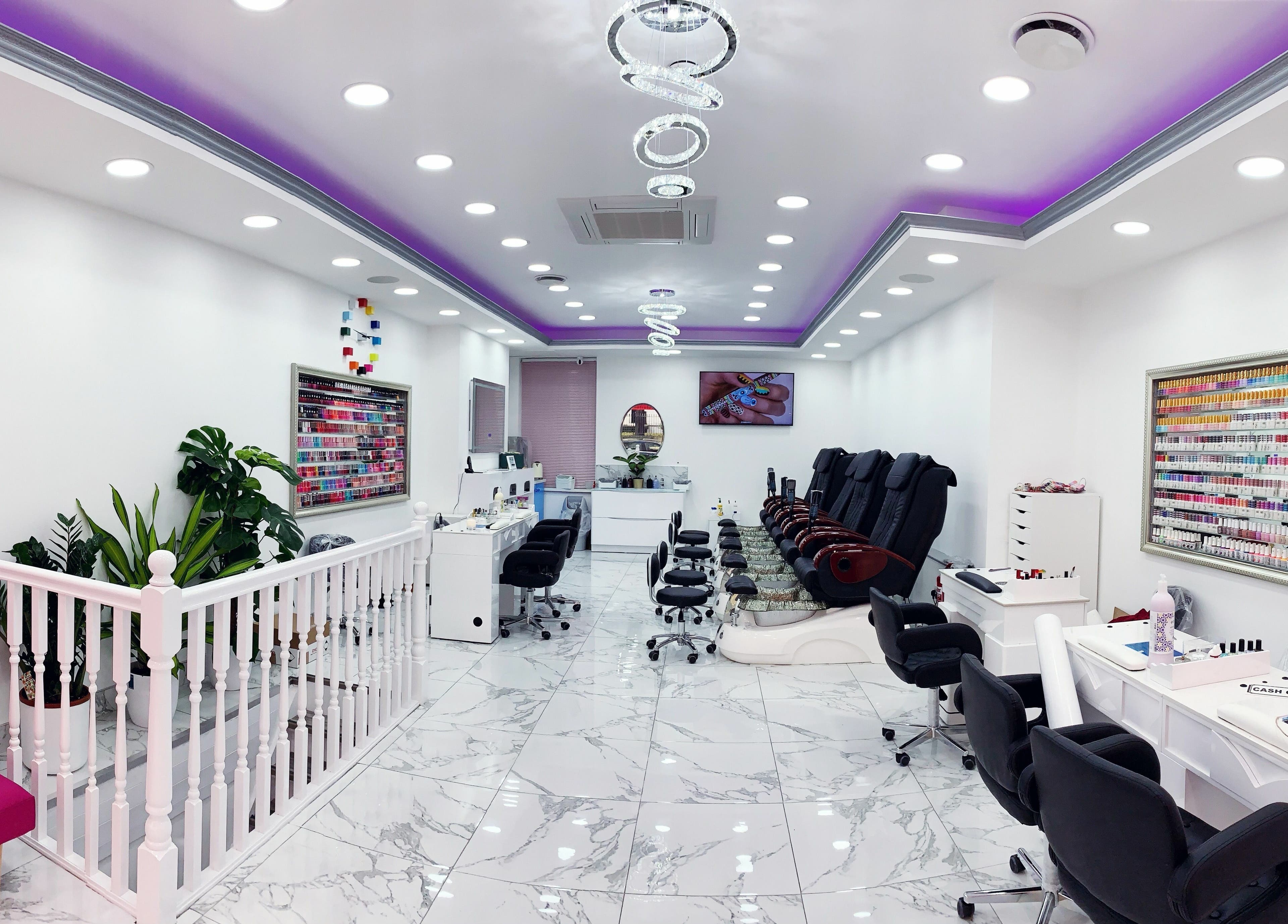 Modern interior of Haus of Colours, London, England, GB with sleek nail stations and vibrant lighting.