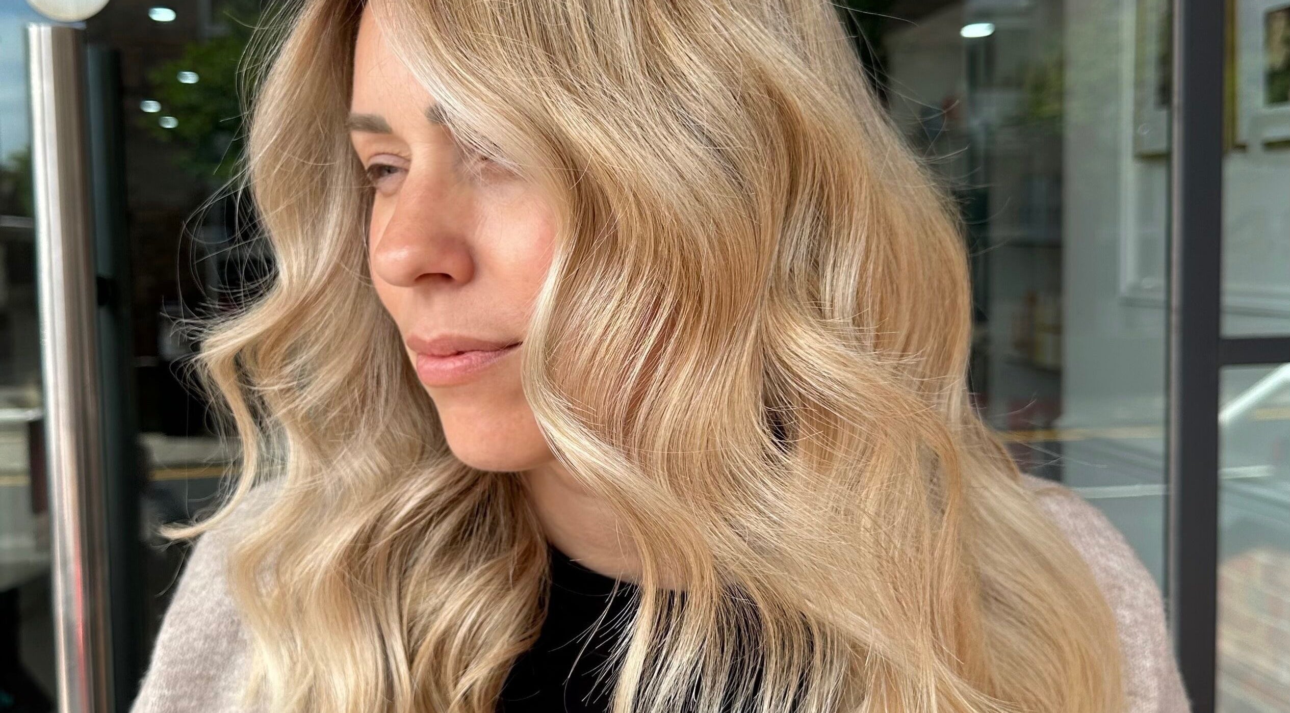 Elegant blonde waves styled at Emma Walker Hairstylist in Chelmsford, England, GB.