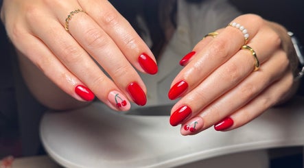Stylish cherry nail art at Beauty Blooms By Abigail in Portsmouth, England, GB; elegant red themed manicure.