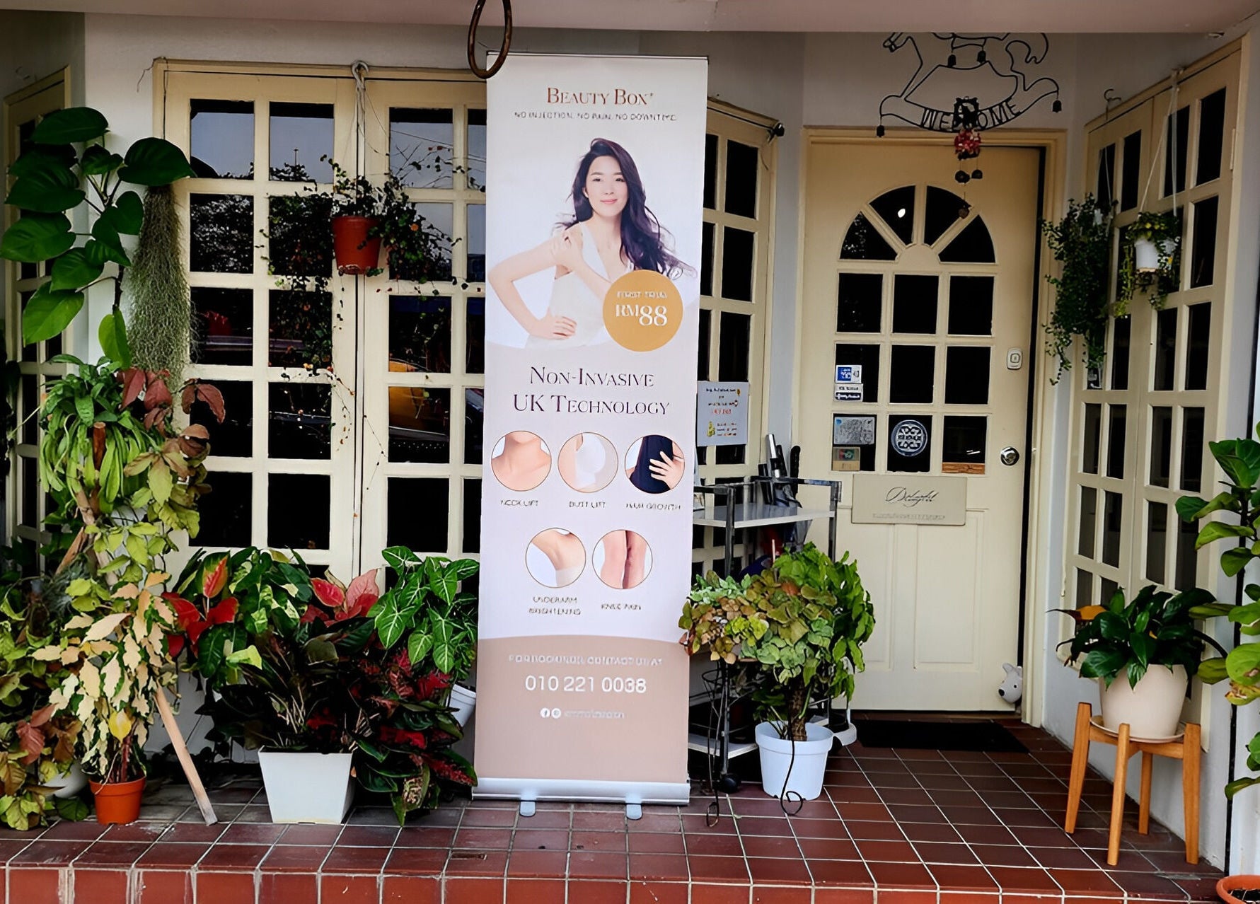 Entrance of Emma Lizs Subang Jaya adorned with lush plants and wellness banner in Subang Jaya, Selangor, MY.