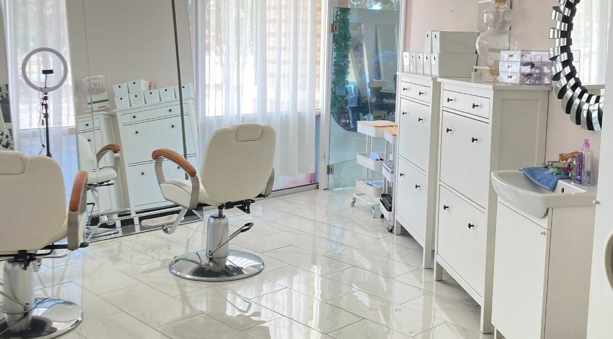 Modern, bright interior of Beauty Concepts Salon in Arlington, Texas, showcasing styling stations and sleek decor.