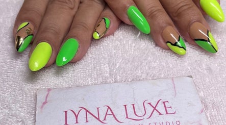 Neon and gold nail art at Lyna Luxe in Bridgetown, BB showcasing intricate design and vibrant colors.