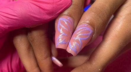 Stylish butterfly nail art at Lyna Luxe, Bridgetown, BB enhances beauty with delicate purple design.
