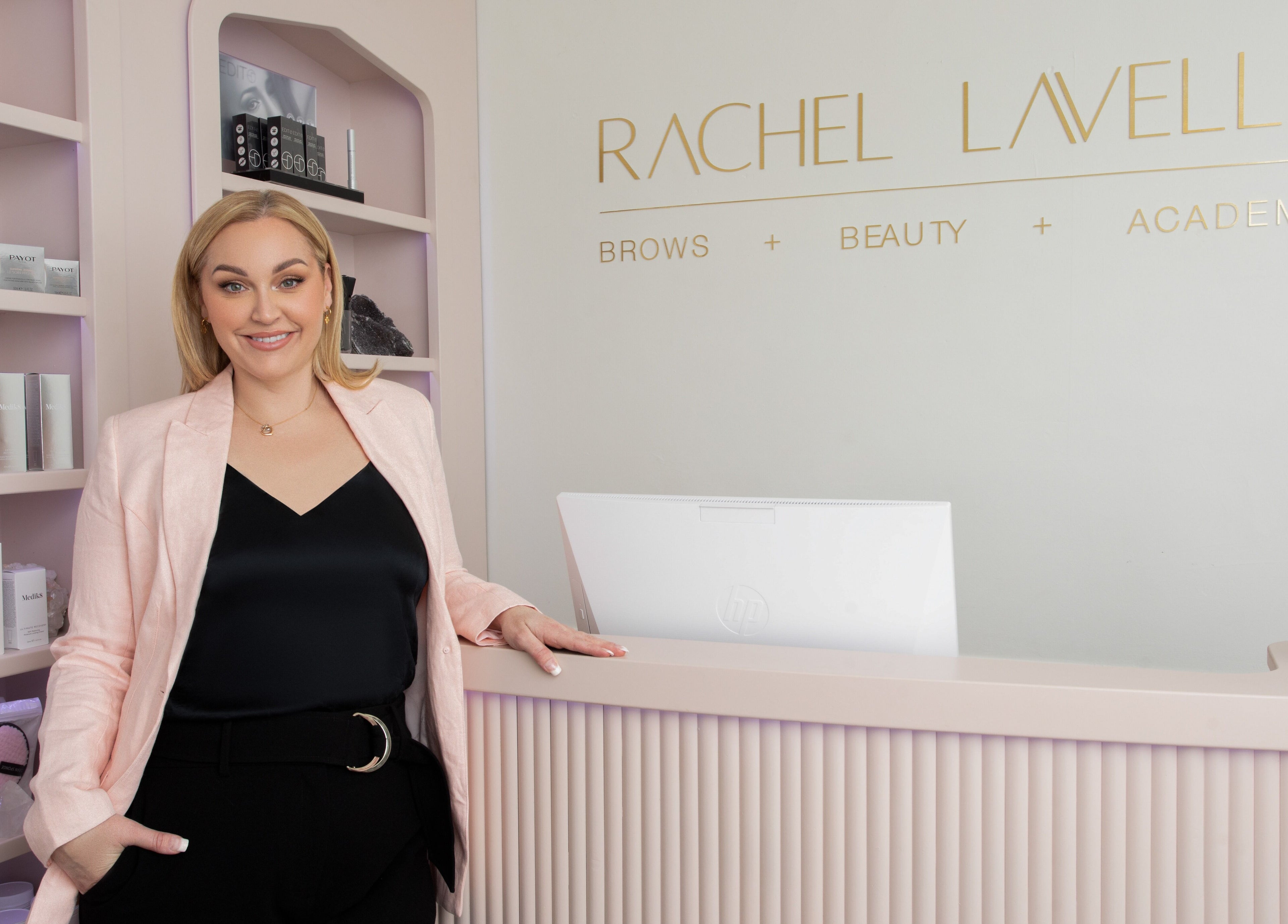 Owner at Rachel Lavelle Brows + Beauty in South Perth, Western Australia, AU, standing beside elegant reception.