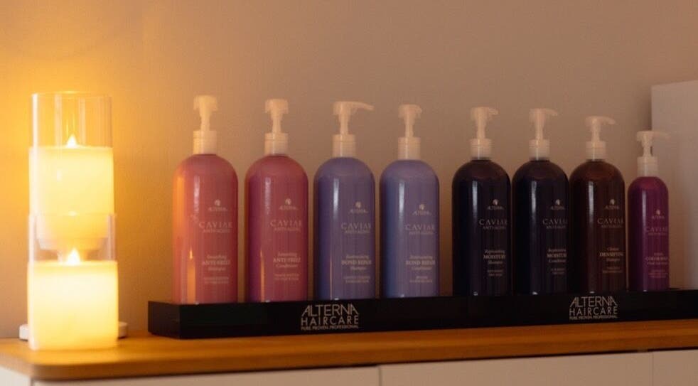 Caviar haircare bottles lit by candles at The Head Spa Retford LTD in Retford, England, GB.
