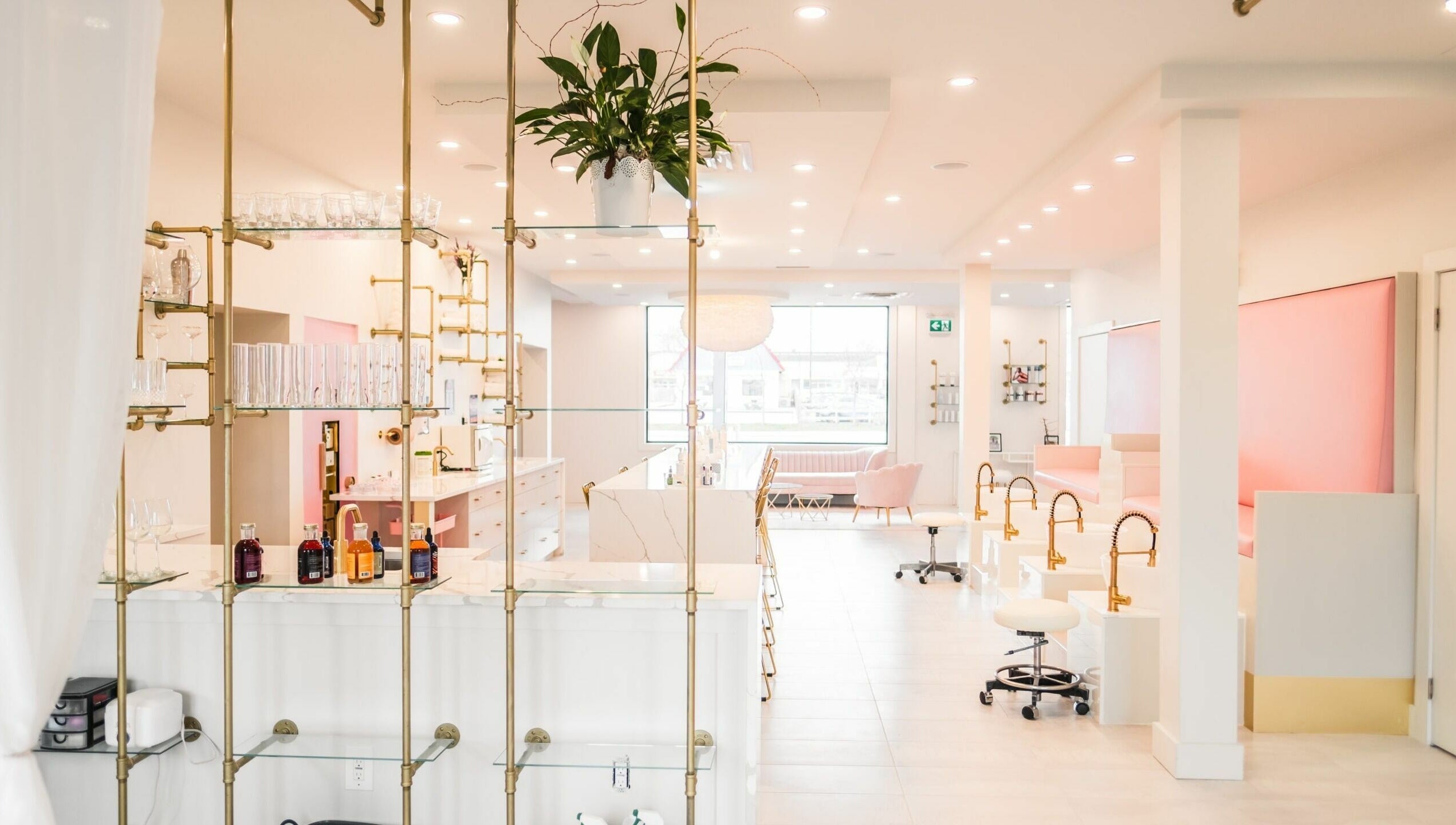 Modern interior of Elixir Beauty Mixology in Niagara Falls, Ontario, CA, featuring elegant decor and seating.