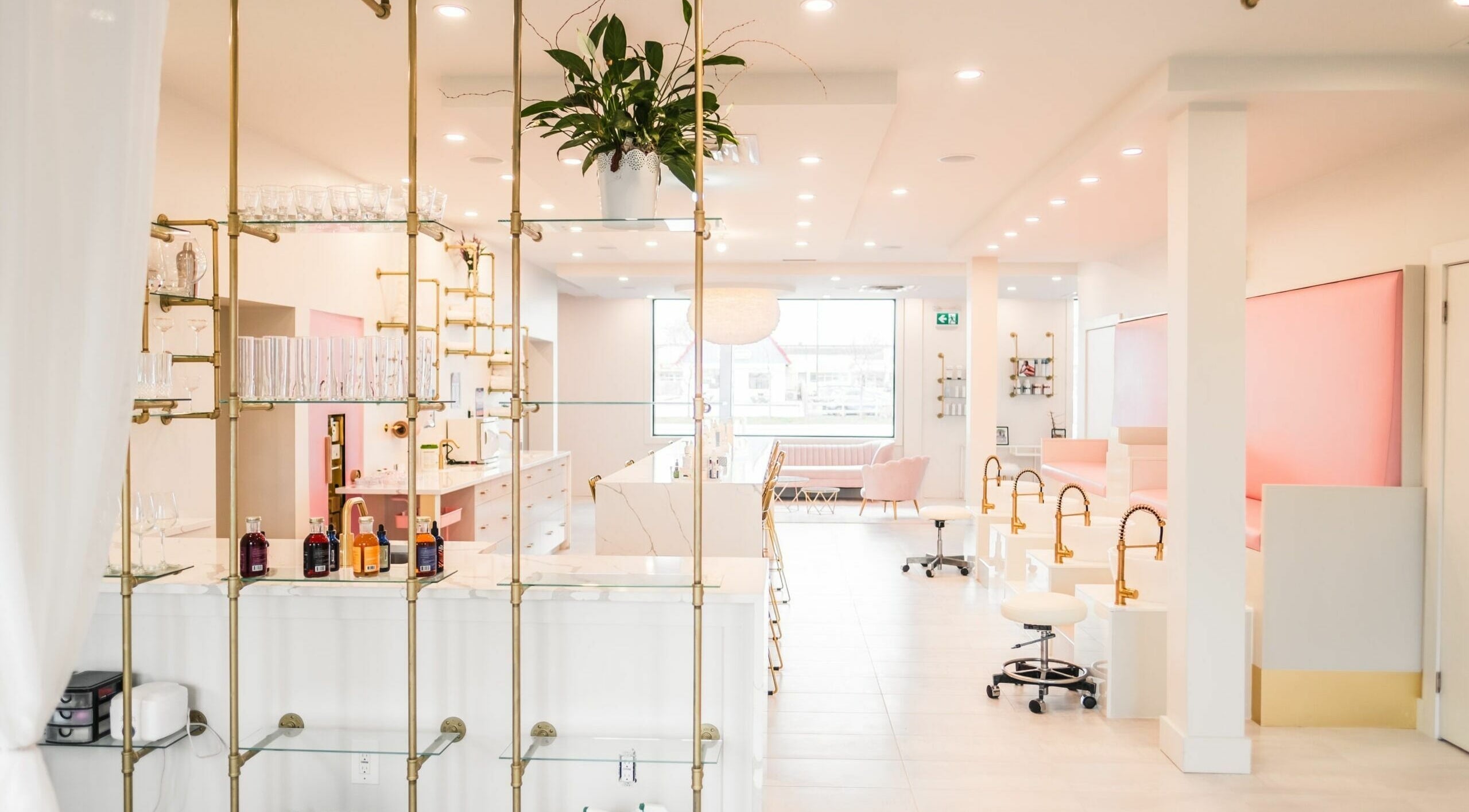 Modern interior of Elixir Beauty Mixology in Niagara Falls, Ontario, CA, featuring elegant decor and seating.