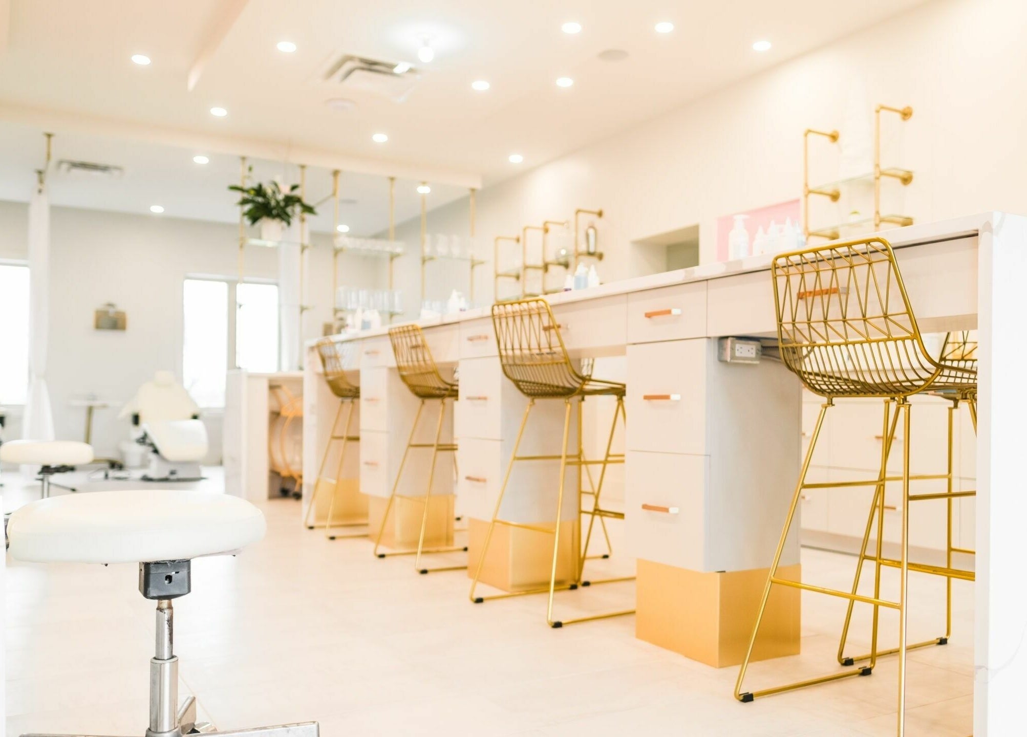 Elegant beauty lounge at Elixir Beauty Mixology in Niagara Falls, Ontario, CA, featuring chic gold accents.