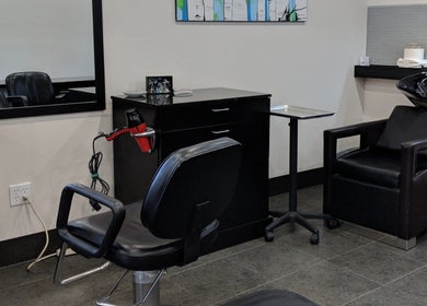 Modern salon station at Kendal at Cypress Avenue, Tulsa, Oklahoma, US with styling chair and hair tools.