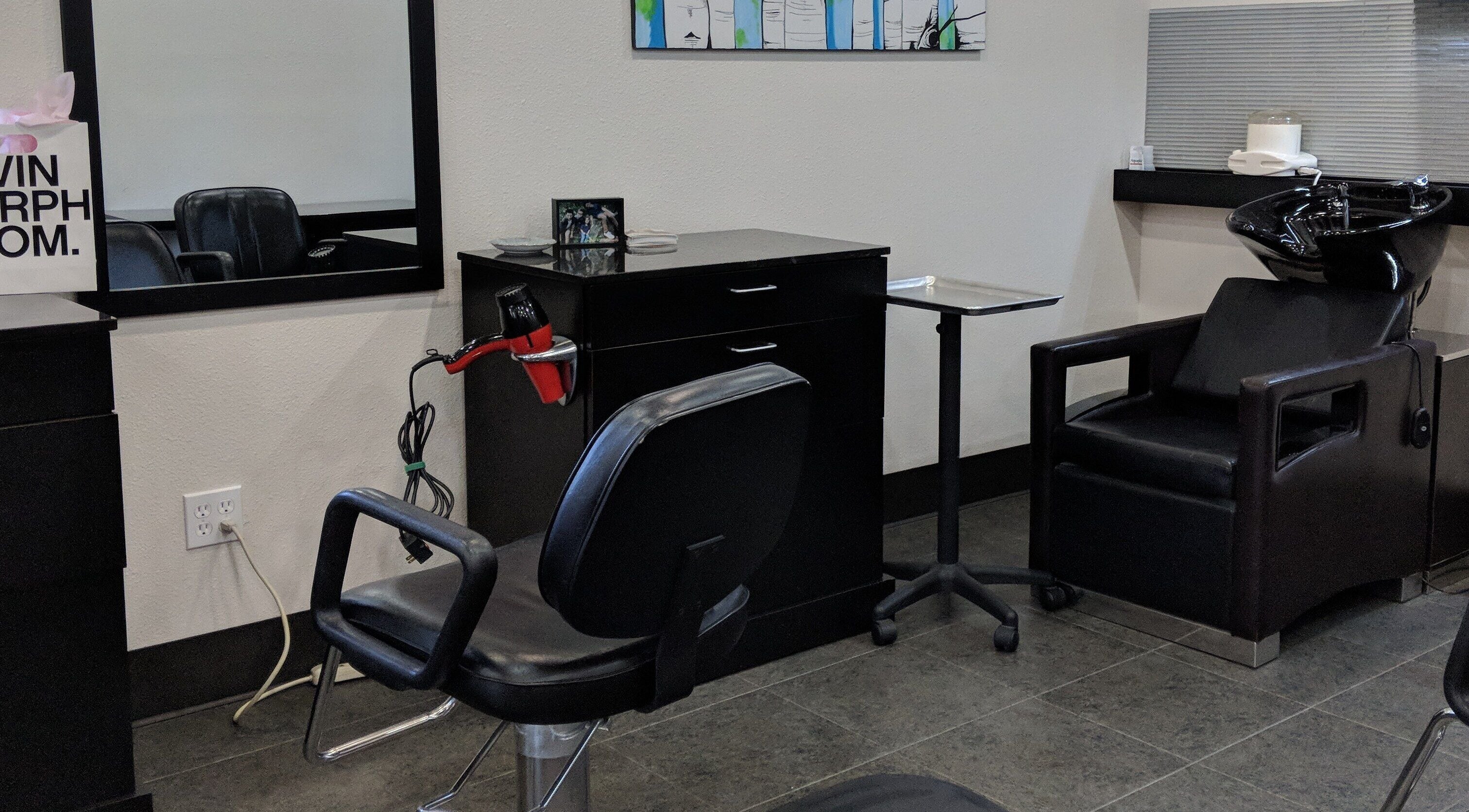 Modern salon station at Kendal at Cypress Avenue, Tulsa, Oklahoma, US with styling chair and hair tools.