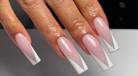 Styled nails in soft pink and white at Color Me Crazy Nail Salon, Los Angeles, California, US.
