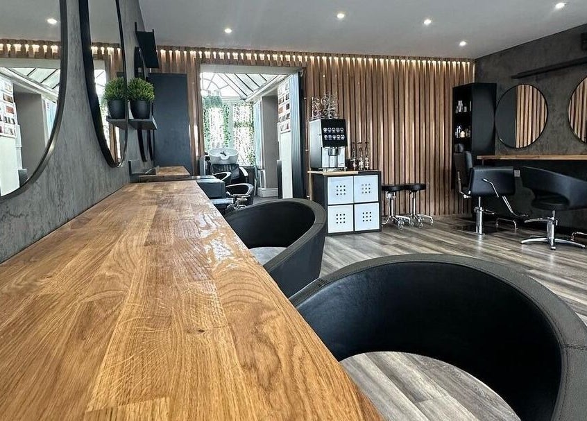 Modern salon interior at BroDans Hair & Beauty Lounge, Cardiff, Wales, GB with elegant decor and styling chairs.