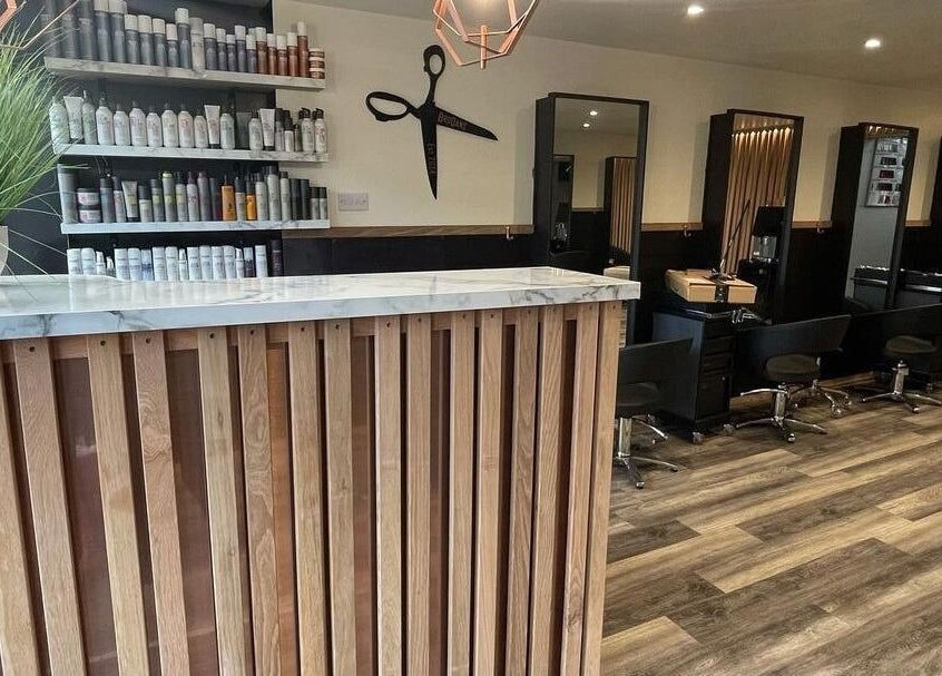 Modern interior of BroDans Hair & Beauty Lounge in Cardiff, Wales, GB with wooden decor and styling stations.